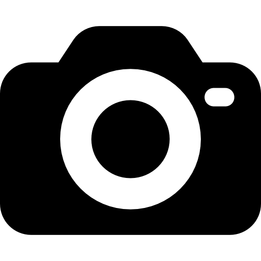 Black camera icon with a round lens in the center and a small flash on the top right. Icon