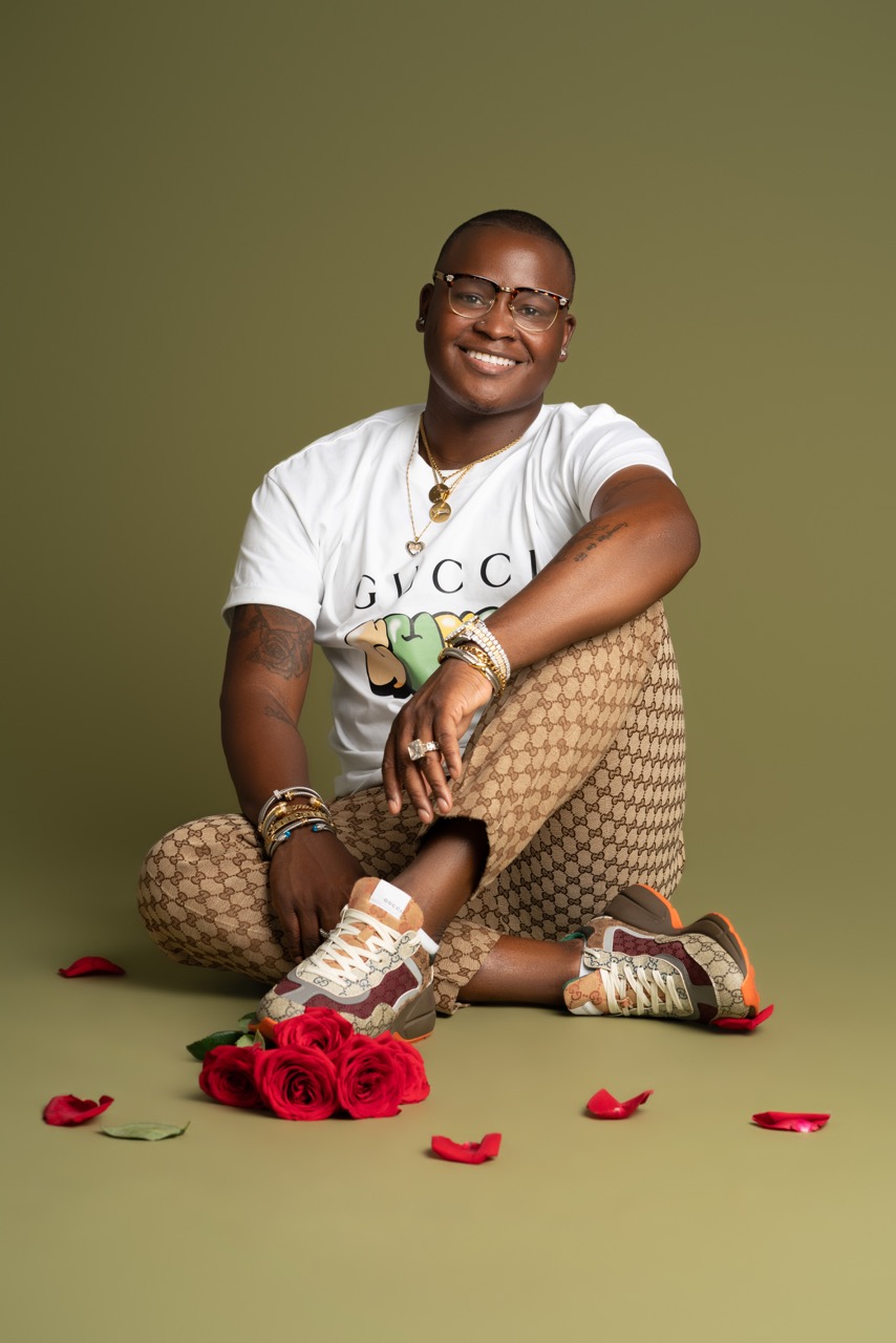 Model poses with flowers wearing gucci from head to toe, beautiful glasses Mild Studios Toronto, Ontario