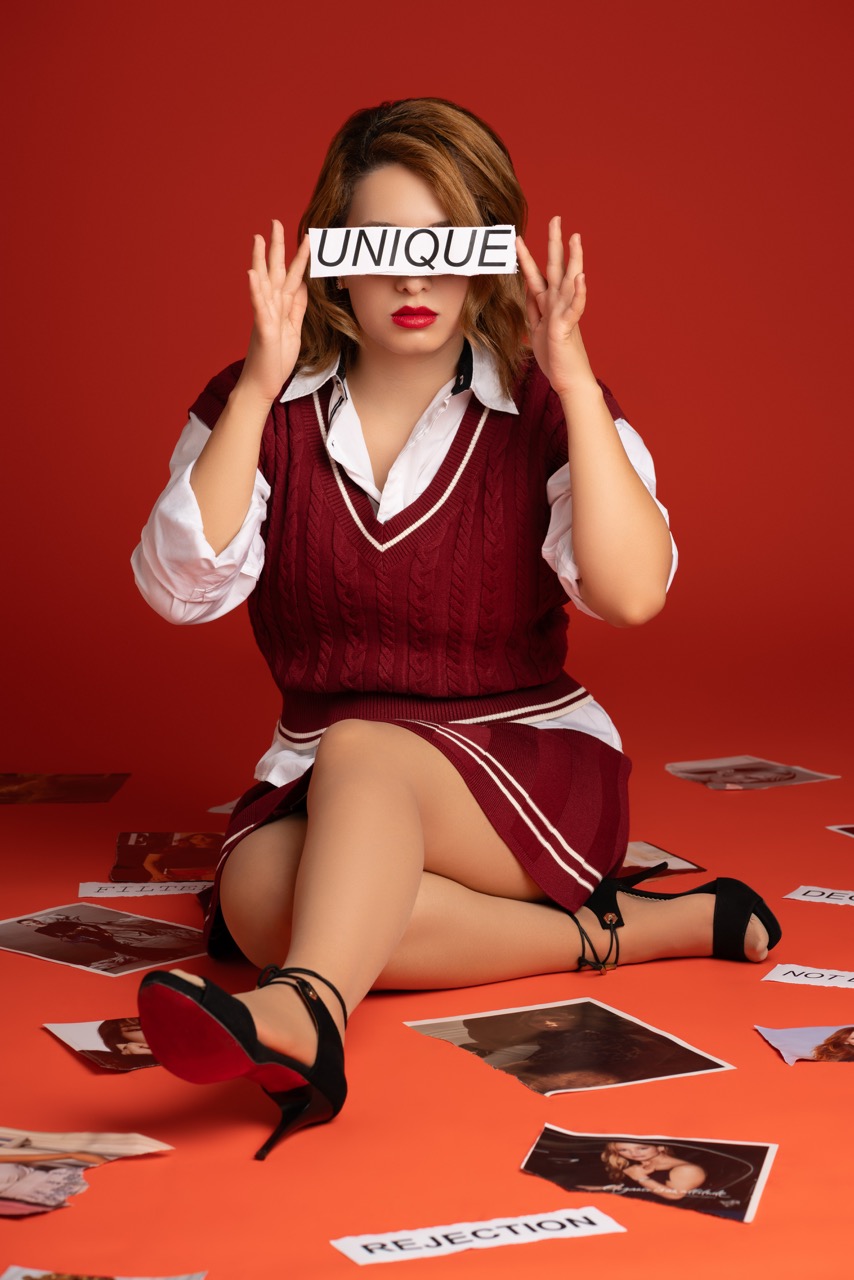 Model poses in schoolgirl attire, ripping magazines I am worthy Mild Studios Toronto, Ontario
